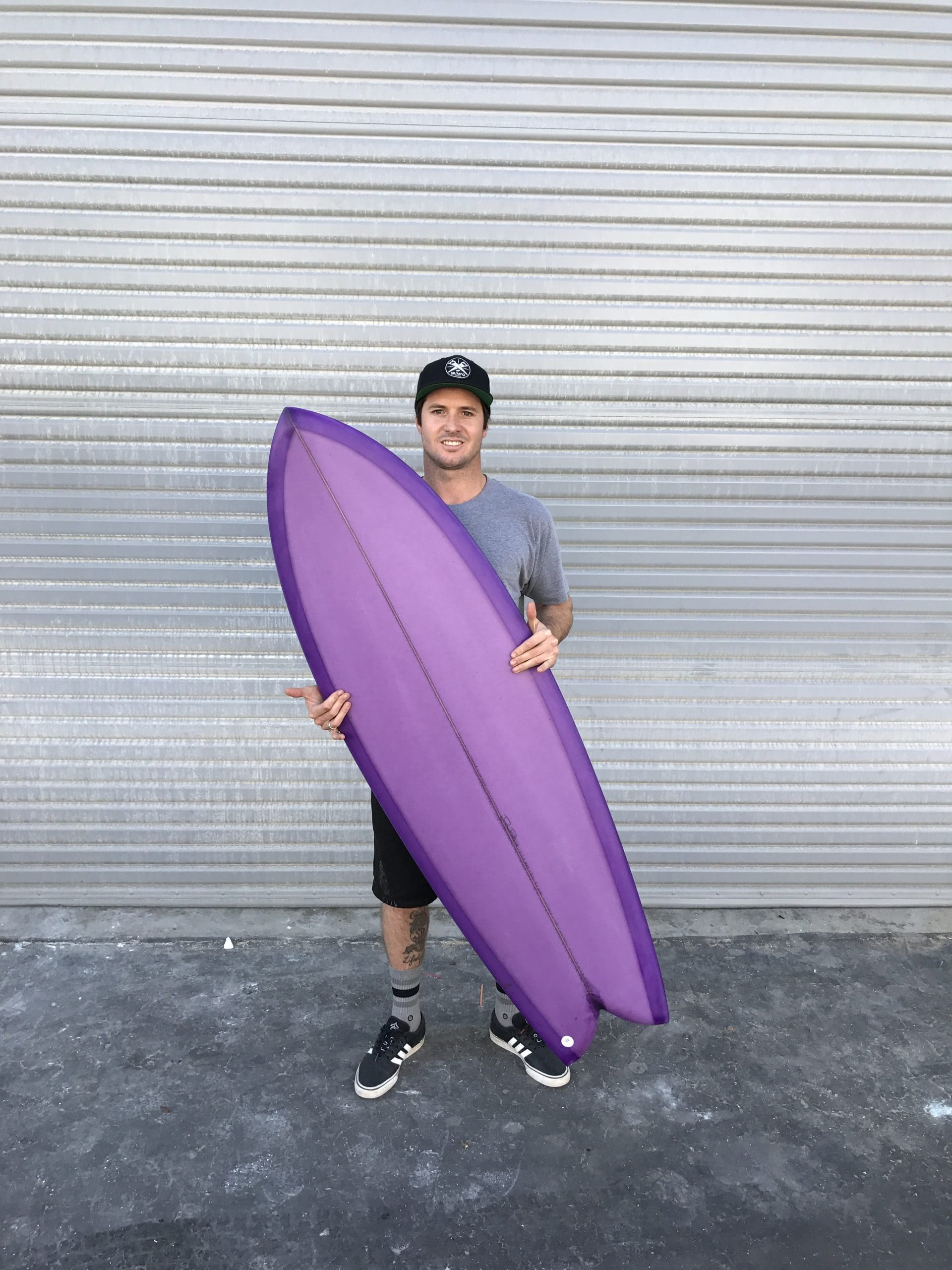 Guy holding a purple surf table