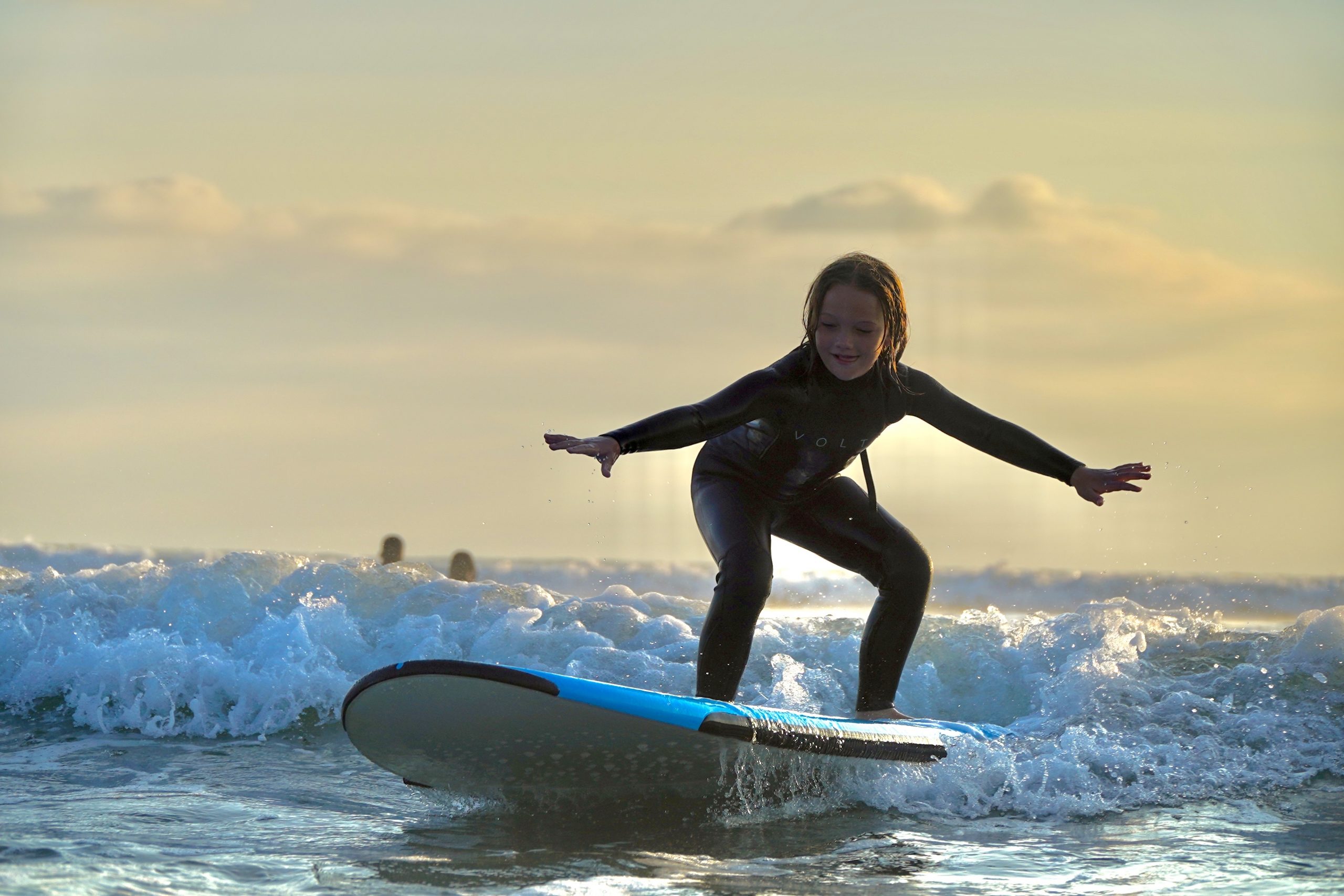girl learning to surf in the california sea