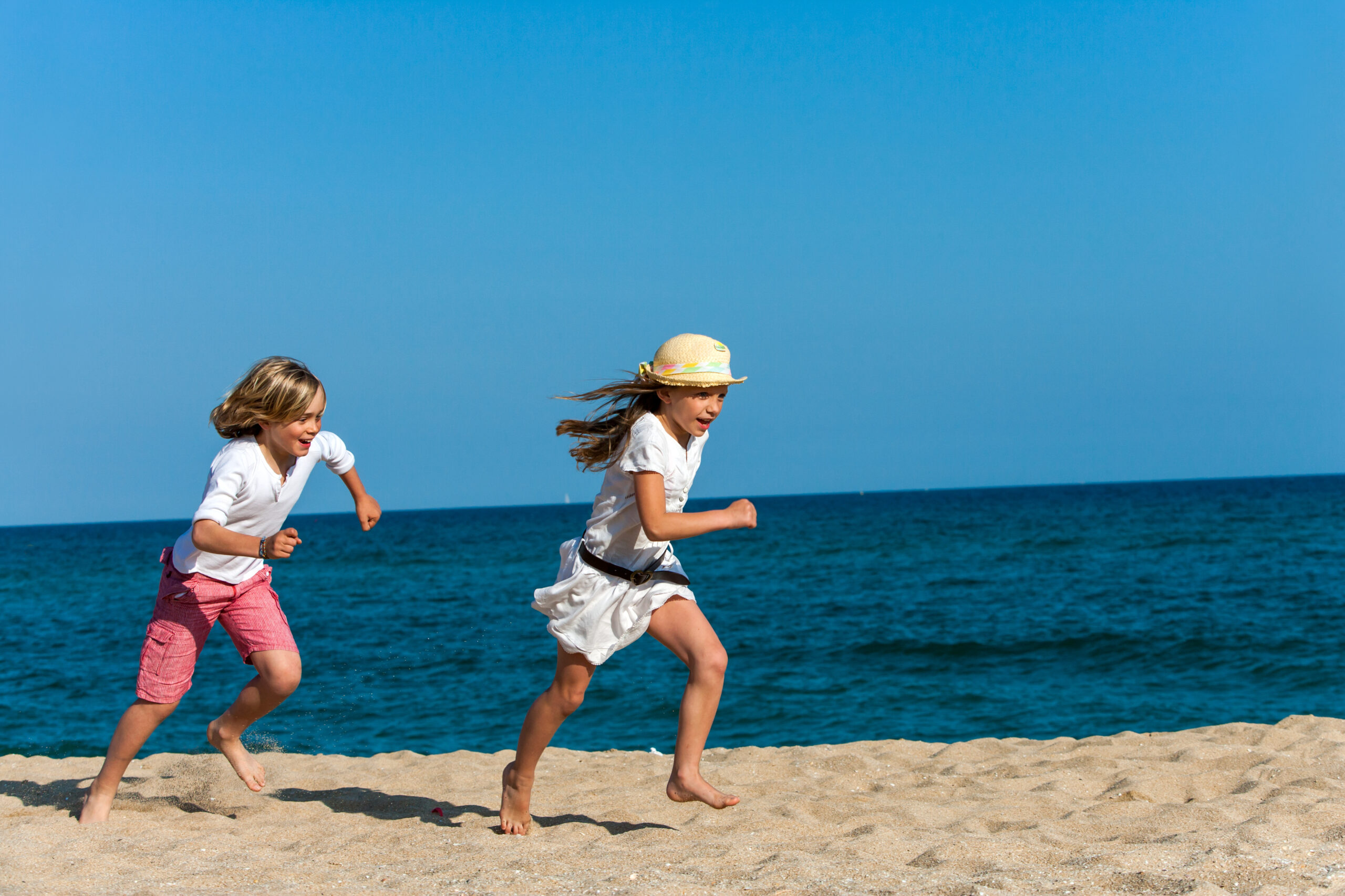 Kids running on the beach
