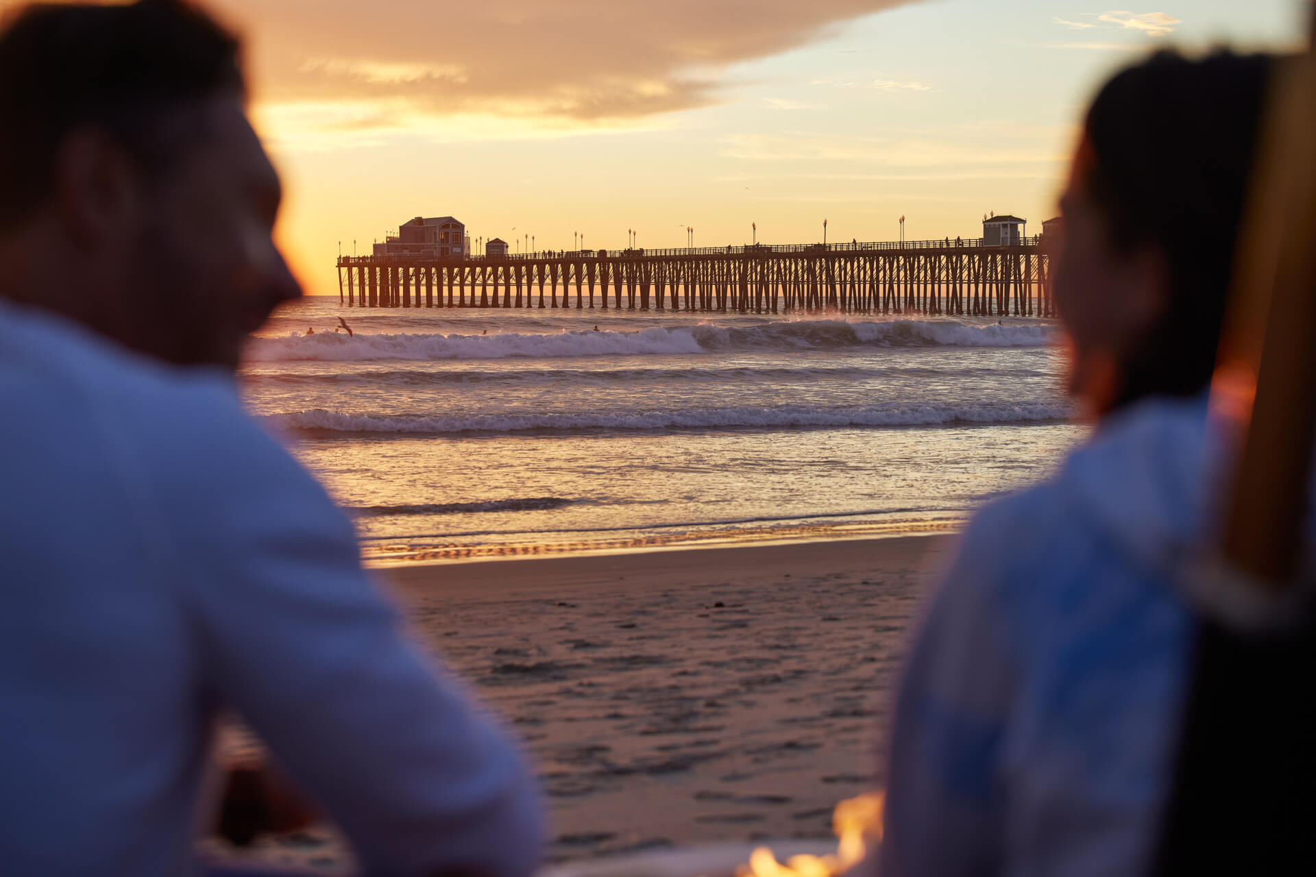 A couple admiring the Pier in Oceanside during the sunset