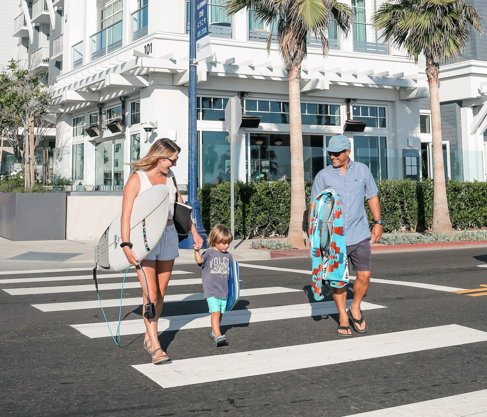Guests walking with surfboards
