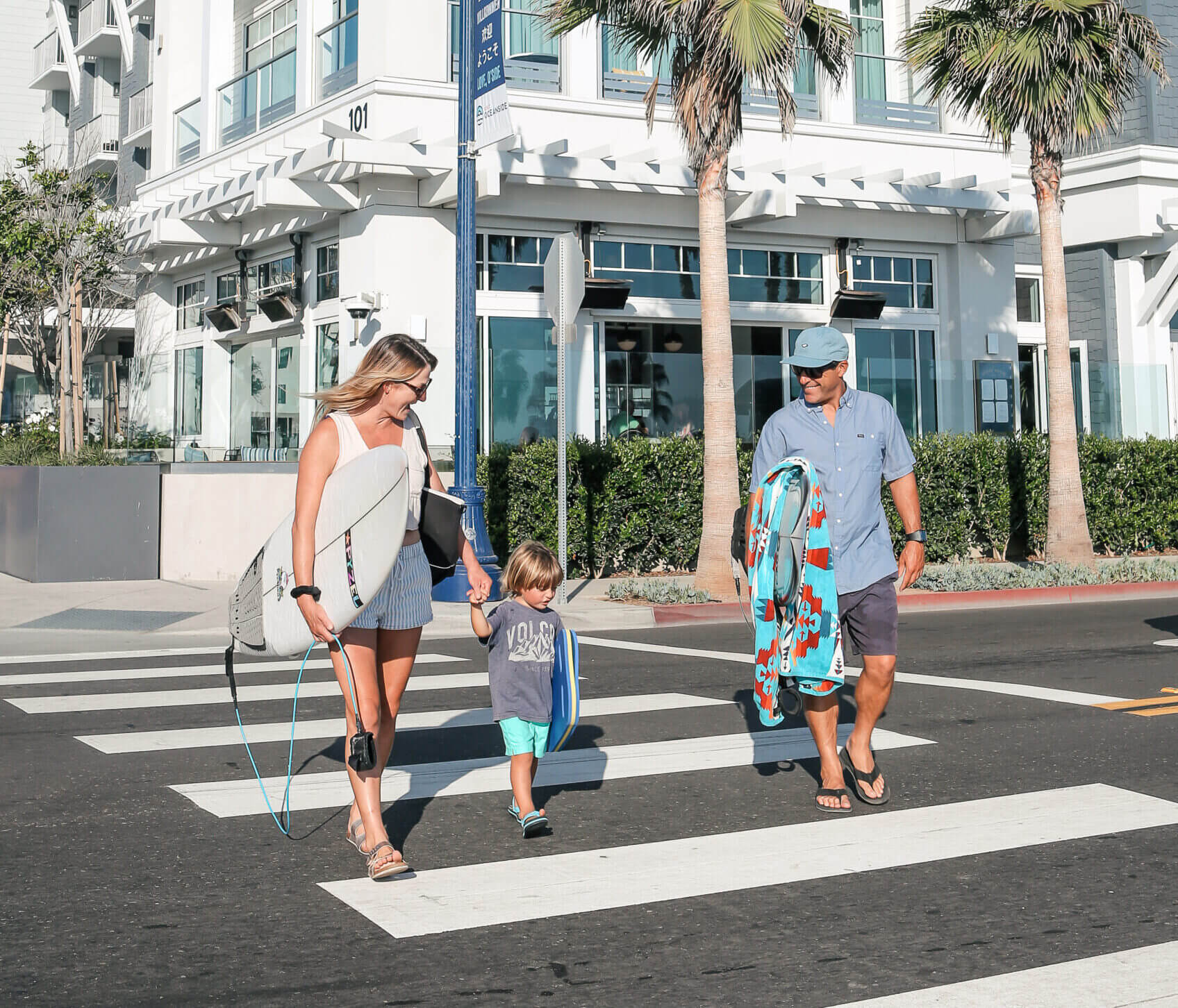 Family crossing the street to go to the Ocean