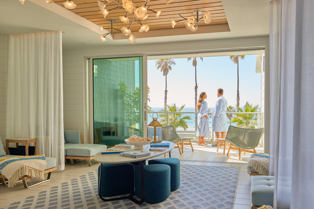 A couple having a relaxing stay in front of the sea in Oceanside Seabird room with balcony
