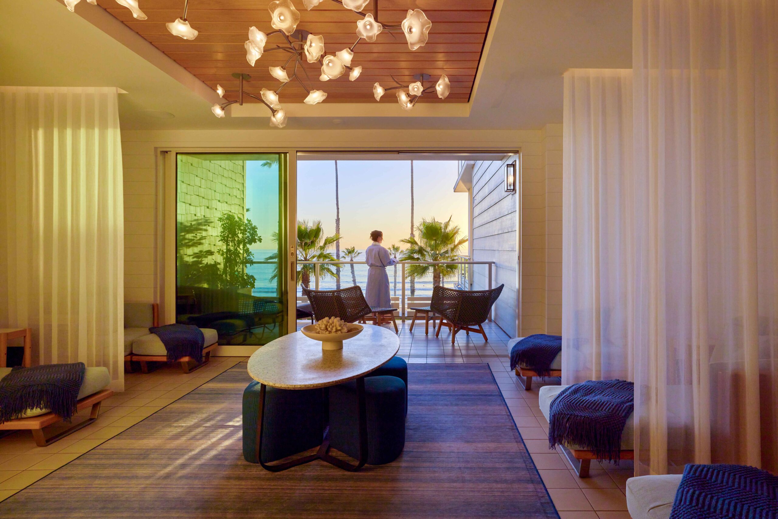 Sunny's Spa woman looking at ocean from balcony